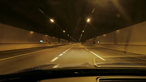 Interior view personal perspective of a car driving through a tunnel at night Video stock 82694991