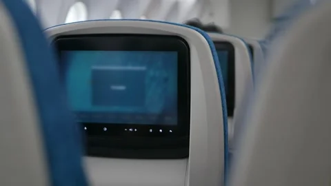 Interior view to personal screen entertainment on airplane seat ready for d.. Vídeos de archivo 330794543