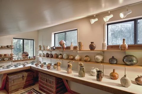Interior view of a potter's workshop, rows of completed ceramic work, vases.. Stock Photos
