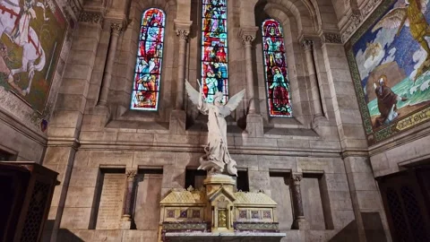 Interior view of the Sacré-Cœur Basilica with an angel statue, glass windows Stock Footage 314700706