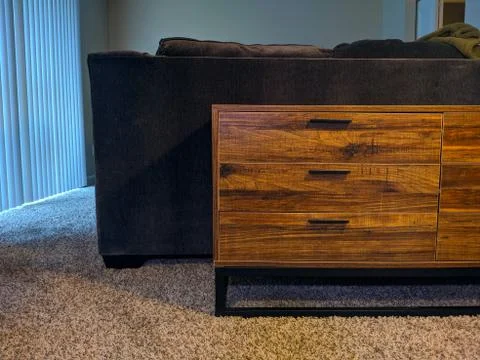 Interior view of a set of drawers behind a large, dark sofa Stock Photos