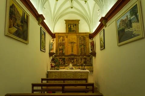 Interior view of a small chapel with altar and religious artwork in Alquezar Stock Photos