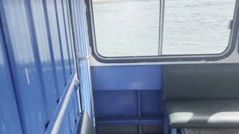 Interior View of Small Ferry Boat with River Water Seen Through Window Vídeos de archivo 342030835