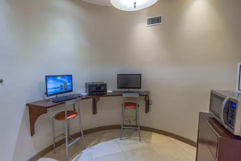 Interior view of small hotel room equipped with computers. Stock Photos