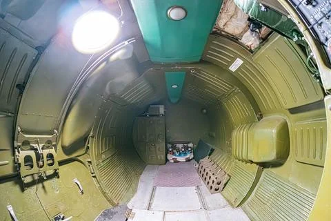 Interior view of a spacecraft cabin, featuring metallic walls with greenish-b Stock Photos
