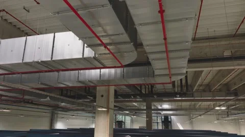 Interior view of vast industrial space with complex ceiling infrastructure .. Stock Footage 337472100