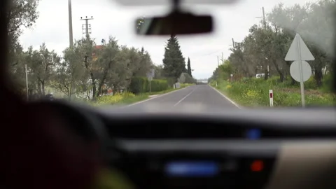 Interior view of the vehicle from back seat. The car is driving in nature on a o Stock Footage 136226059