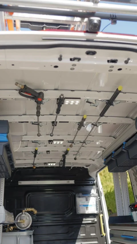 Interior view of white work van showing organized ceiling storage Stock Footage 336418004