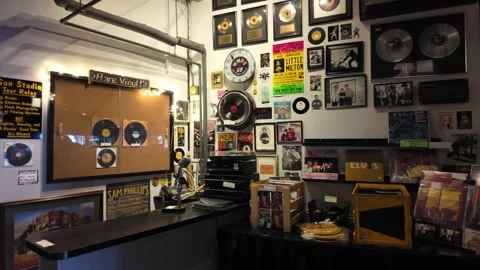Interior of a vintage record store with vinyl records and music memorabilia Stock Footage 336351907