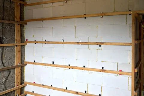 Interior wall construction features white autoclaved aerated concrete block w Stock Photos