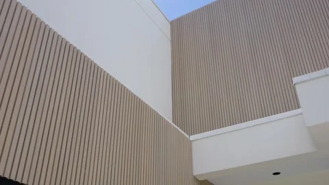 Interior wall with vertical lines creating textured pattern. Ceiling at right Stock Footage 282947186