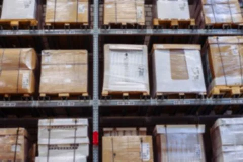 Interior of warehouse blurring. Rows of shelves with boxes Foto stock