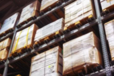 Interior of warehouse blurring. Rows of shelves with boxes Foto stock