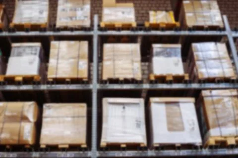 Interior of warehouse blurring. Rows of shelves with boxes Stock Photos