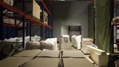 Interior of a warehouse storage with pallets, high shelves, boxes, loaders. Stock Footage 193513982