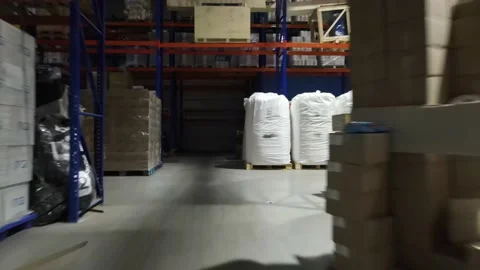 Interior of a warehouse storage with pallets, high shelves, boxes, loaders. Stock Footage 193514419