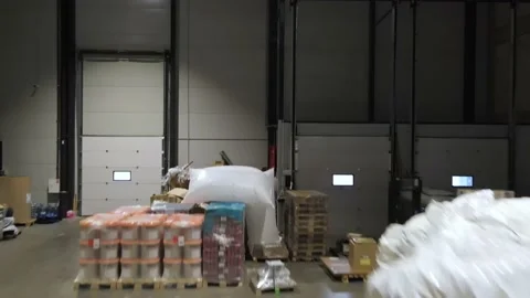 Interior of a warehouse storage with pallets, high shelves, boxes, loaders. Stock Footage 193515298
