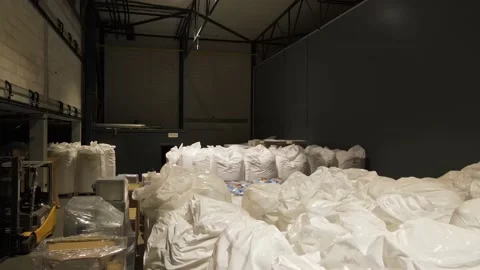 Interior of a warehouse storage with pallets, high shelves, boxes, loaders. Stock Footage 193515501