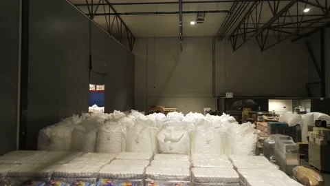 Interior of a warehouse storage with pallets, high shelves, boxes, loaders. Stock Footage 193515952