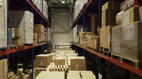 Interior of a warehouse storage with pallets, high shelves, boxes, loaders. Stock Footage 193517123