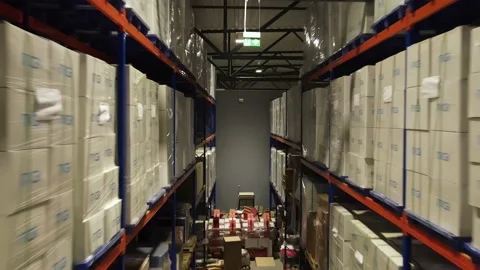 Interior of a warehouse storage with pallets, high shelves, boxes, loaders. Stock Footage 193519218