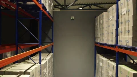 Interior of a warehouse storage with pallets, high shelves, boxes, loaders. Stock Footage 193520175