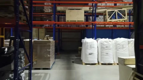 Interior of a warehouse storage with pallets, high shelves, boxes, loaders. Stock Footage 193520875