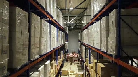 Interior of a warehouse storage with pallets, high shelves, boxes, loaders. Stock Footage 193521933