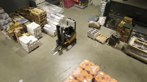 Interior of a warehouse storage with pallets, high shelves, boxes, loaders. Stock Footage 193531049
