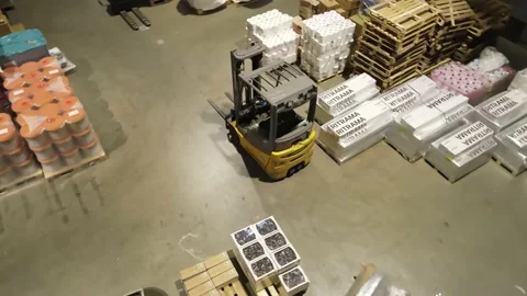 Interior of a warehouse storage with pallets, high shelves, boxes, loaders. Stock Footage 193531923
