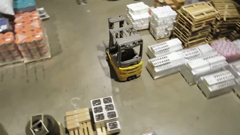 Interior of a warehouse storage with pallets, high shelves, boxes, loaders. Stock Footage 193532811