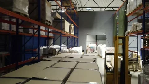 Interior of a warehouse storage with pallets, high shelves, boxes, loaders. Stock Footage 193535406