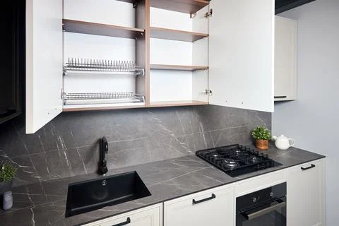 Interior of white and grey kitchen, horizontal linear layout. Luxury modern Stock Photos