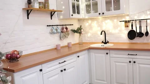 Interior of white kitchen with decorated Christmas tree and garlands. Stock Footage 144119376