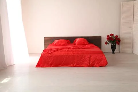 The Interior of the white room with a bed with red Stock Illustration