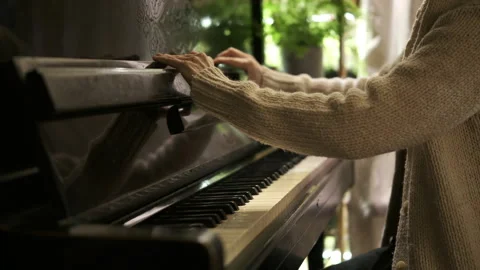 Interior. Woman's hands in white sweater open old vintage piano Stock Footage 265662176