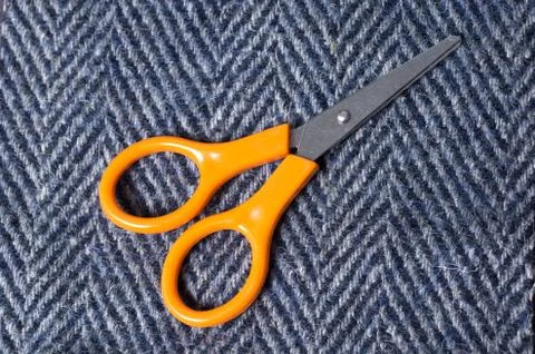 Interlacing the fabric with a close-up and scissors Stock Photos