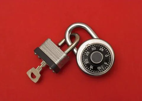 Interlock: two locks are interlocked, one with key and one with number cod... Stock Photos