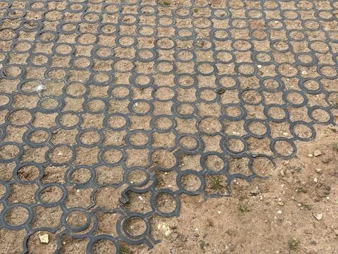 Interlocking Circle Paver Ground Cover Tiles Over Dirt Surface Stock Photos