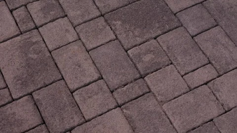 Interlocking concrete paving stones forming geometric walkway pattern Stock Footage 342612301