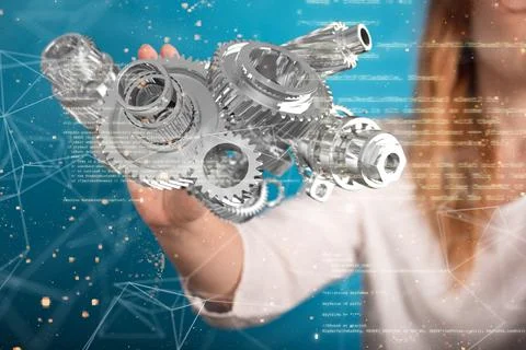 Interlocking gears against a technology background in front of a person pointing 스톡 사진