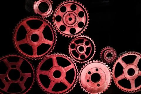 Interlocking industrial  cogwheels top view on black background Stock Photos