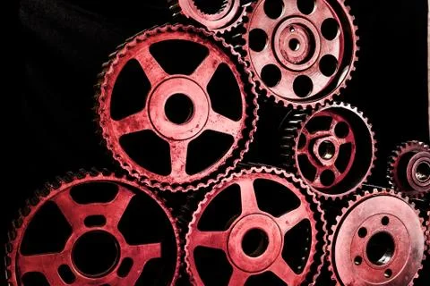 Interlocking industrial  cogwheels top view on black background Stock Photos