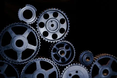 Interlocking industrial  cogwheels top view on black background Stock Photos