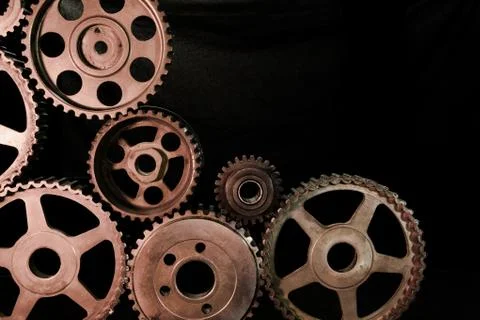 Interlocking industrial  cogwheels top view on black background Stock Photos