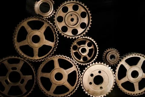 Interlocking industrial  cogwheels top view on black background Stock Photos