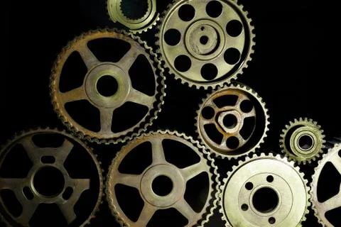 Interlocking industrial  cogwheels top view on black background Stock Photos