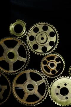 Interlocking industrial  cogwheels top view on black background Stock Photos