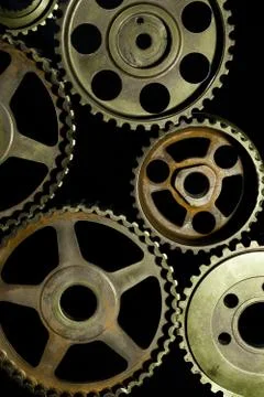 Interlocking industrial  cogwheels top view on black background Stock Photos
