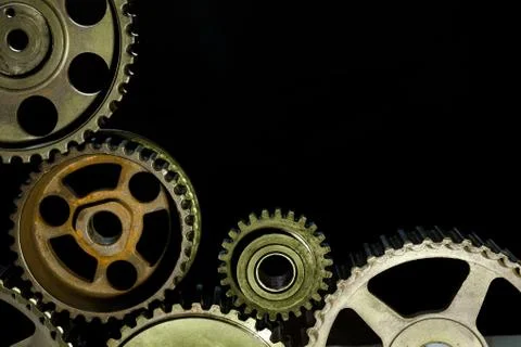 Interlocking industrial  cogwheels top view on black background Stock Photos